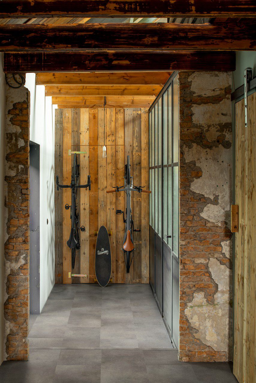 Vinyl flooring tiles Quick-Step Oro Concrete rock installed to a rustic style hallway floor.