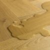 laminaatparkett-kalasaba-quick-step-impressive-esign-cumin-oak Laminaatparkett kalasaba Quick-Step Impressive Design Cumin Oak naturaalne toon ja sorteering. Veelomp laminaadil viitamaks selle veekindlusele.